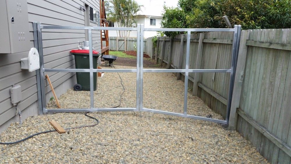 A Metal Gate Is Being Built In The Backyard Of A House — Boambee Home Improvements in Urunga, NSW