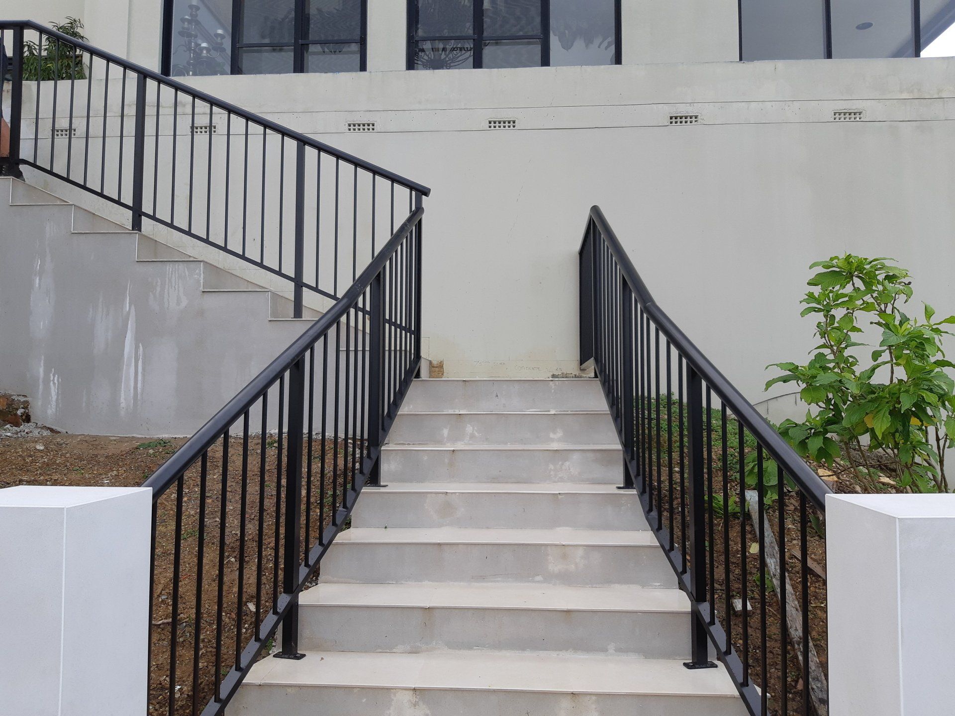 Stairs Leading Up To A Building With A Black Railing — Boambee Home Improvements in Coffs Harbour, NSW