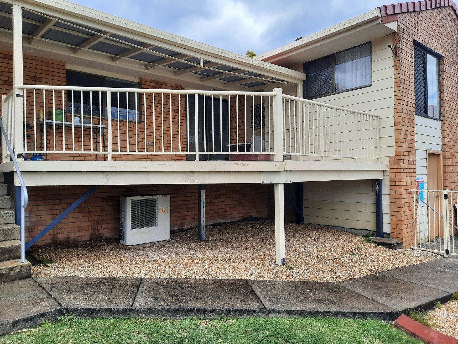 A House With A Balcony And A Brick Wall — Boambee Home Improvements in Coffs Harbour, NSW