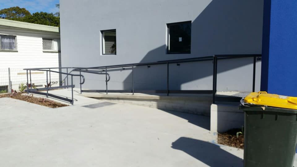 A Building With A Ramp And A Trash Can In Front Of It — Boambee Home Improvements in Nambucca Heads, NSW