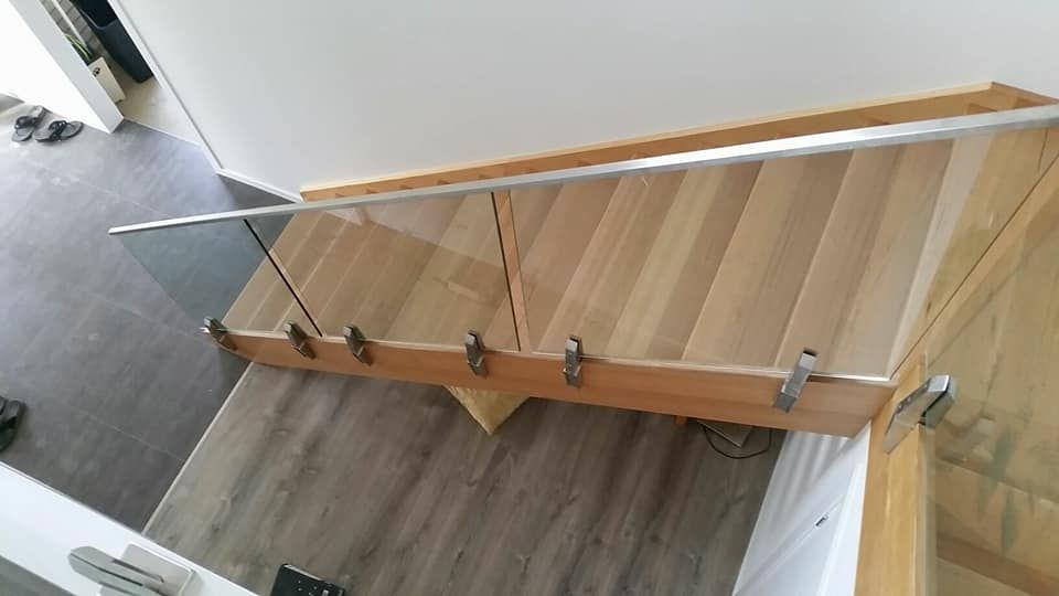 An Aerial View Of A Wooden Staircase With A Glass Railing — Boambee Home Improvements in Coffs Harbour, NSW