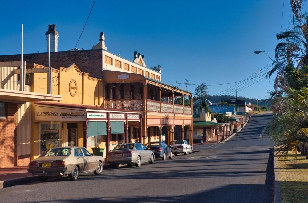 A Row Of Cars Are Parked In Front Of A Building — Boambee Home Improvements in Bowraville, NSW