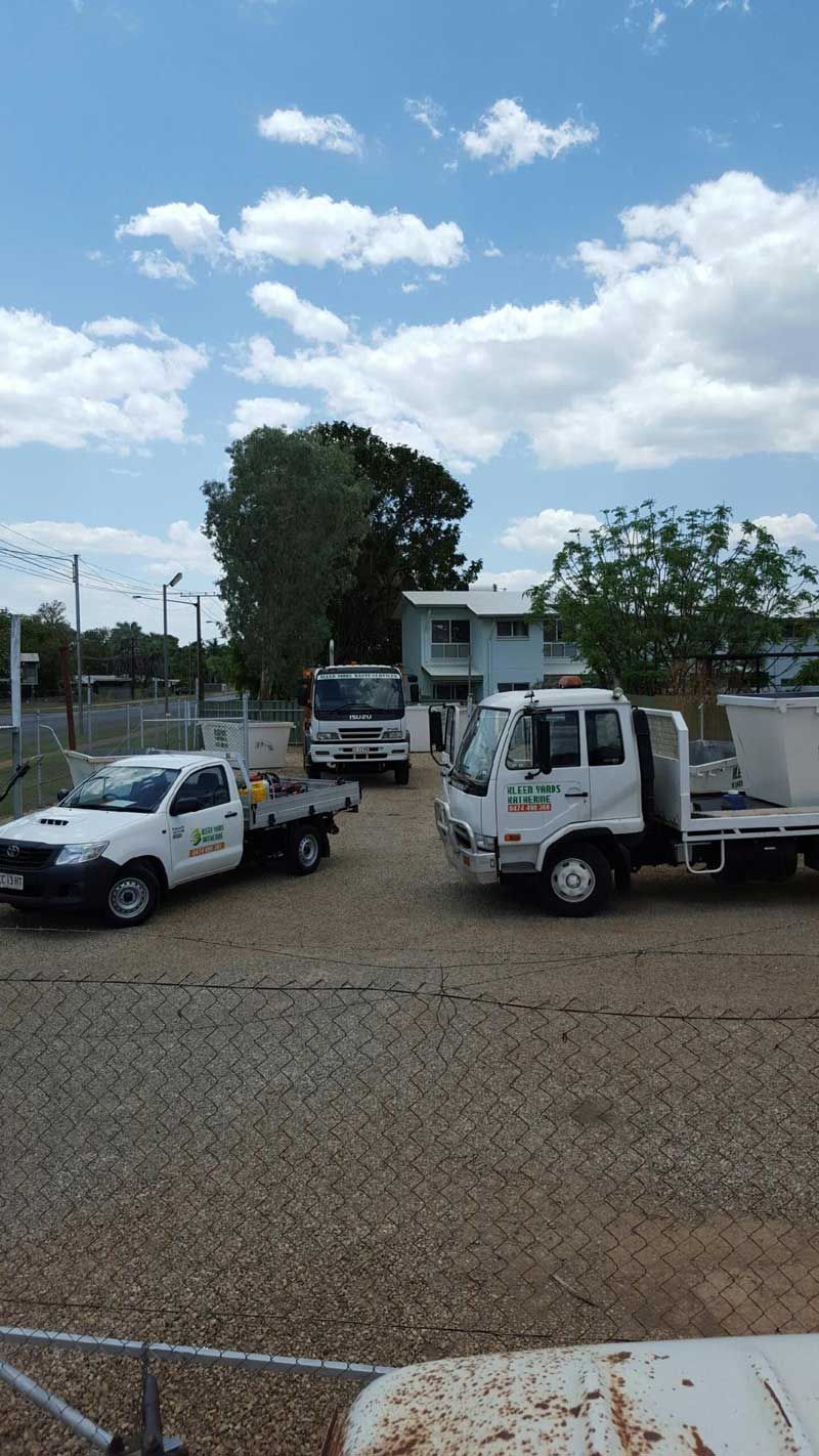A Row of White Trucks Are Parked in a Gravel Lot — KYK Industries in Katherine, NT