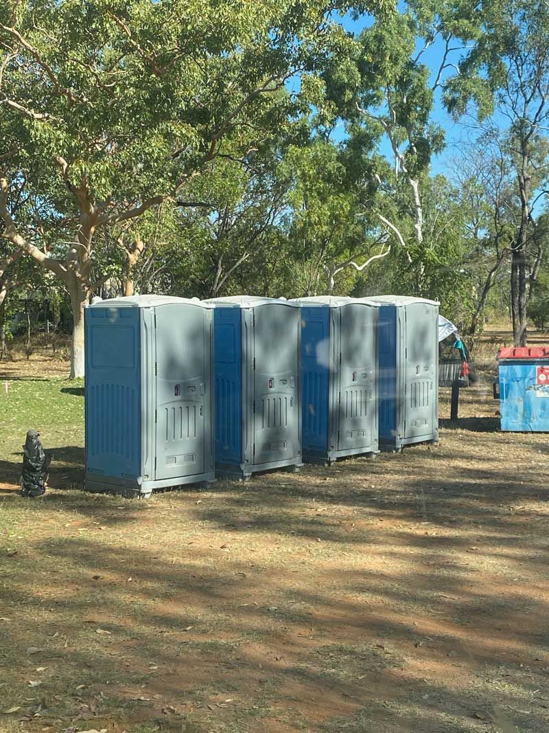 A Row of Portable Toilets Are Lined Up in a Park — KYK Industries in Katherine, NT
