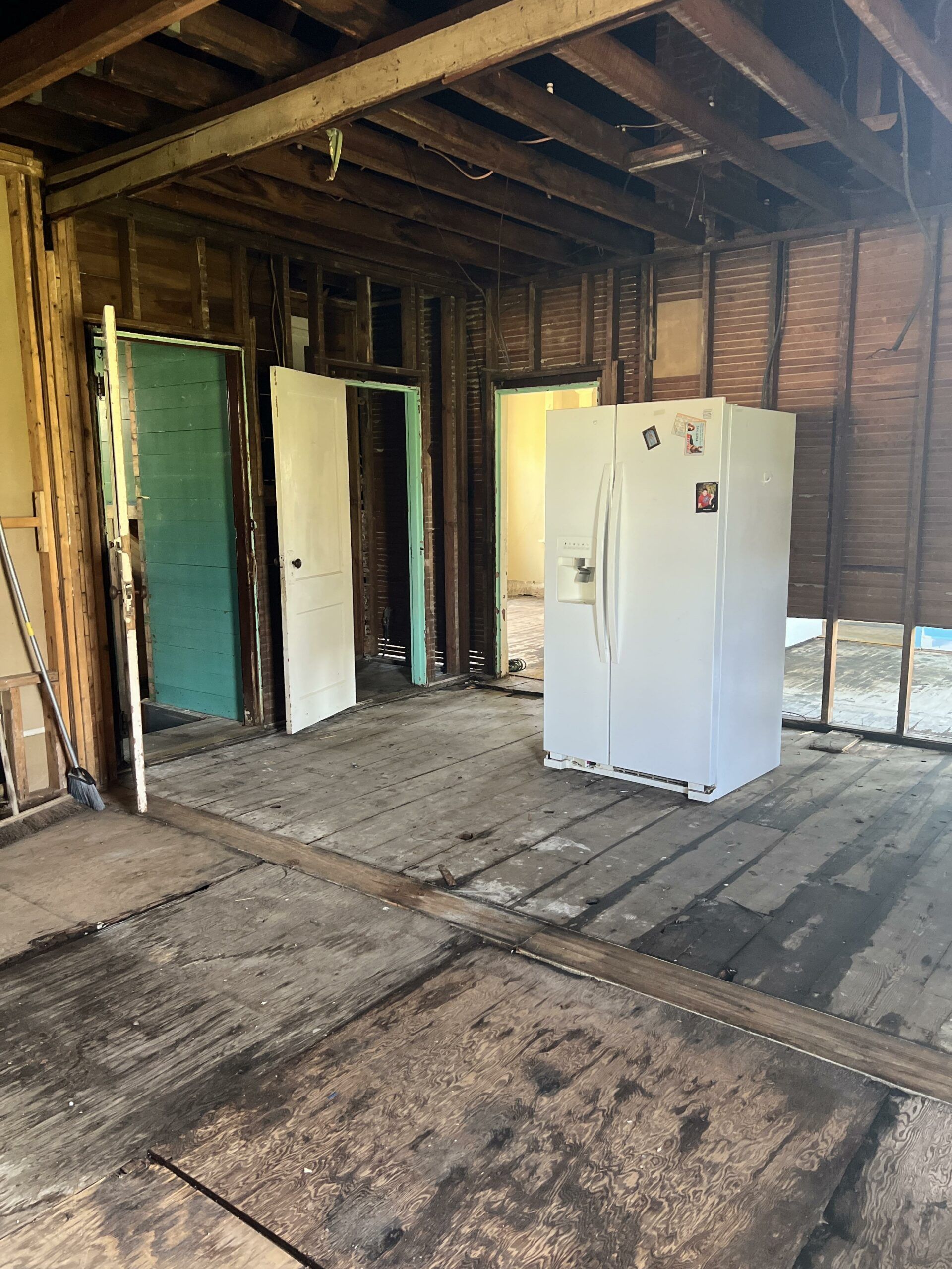 A room with a refrigerator and a freezer in it.