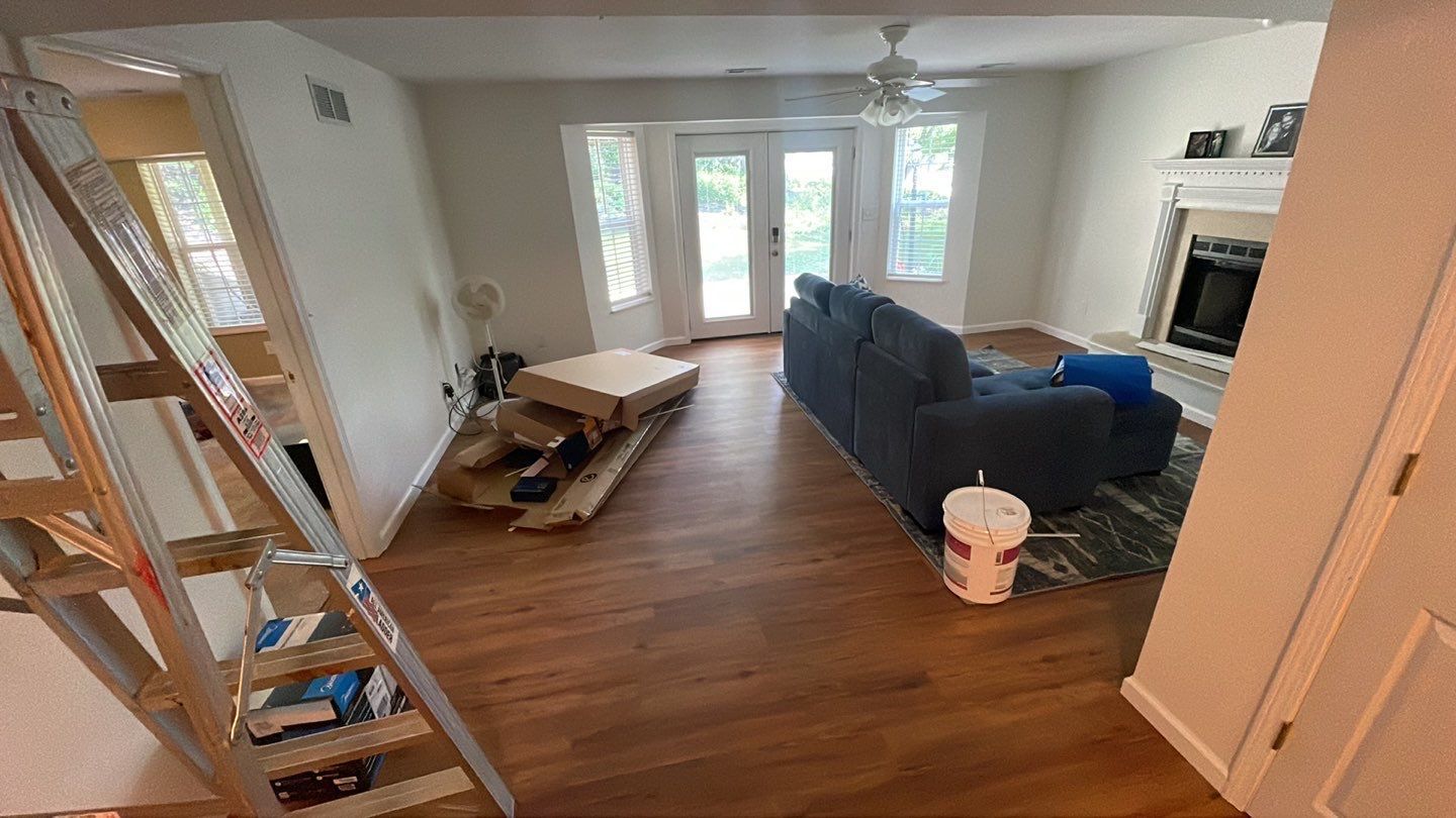 A living room with hardwood floors and a blue couch.