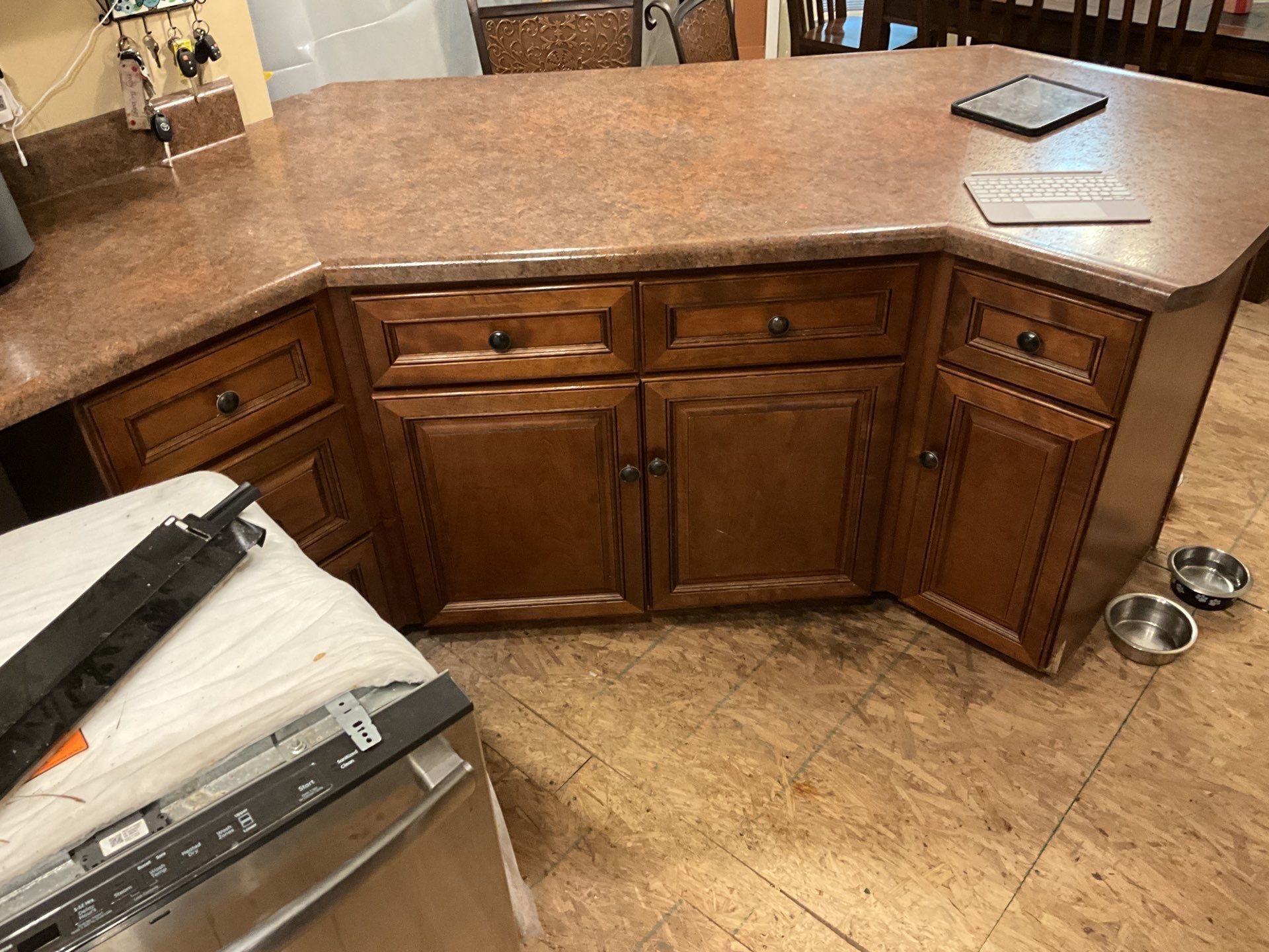 A kitchen with wooden cabinets and a granite counter top