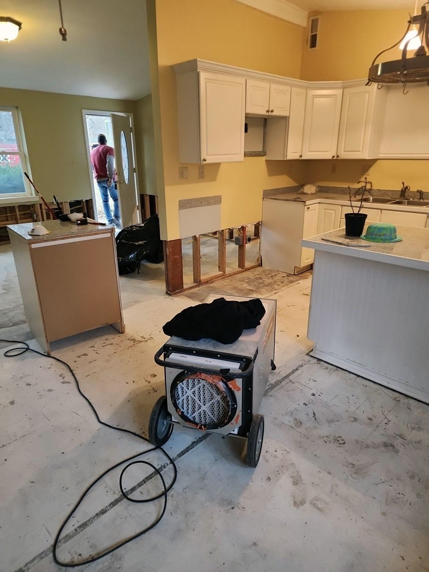 A kitchen under construction with a heater on the floor.