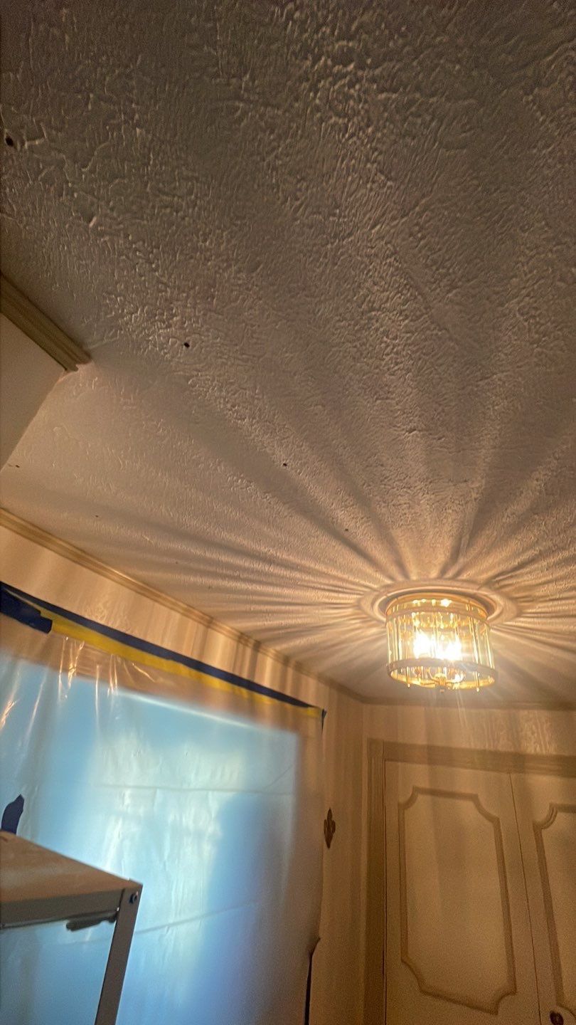 A light fixture is hanging from the ceiling of a room.