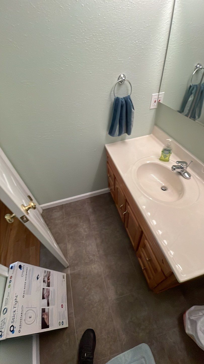 A bathroom with a sink , mirror and towel rack.