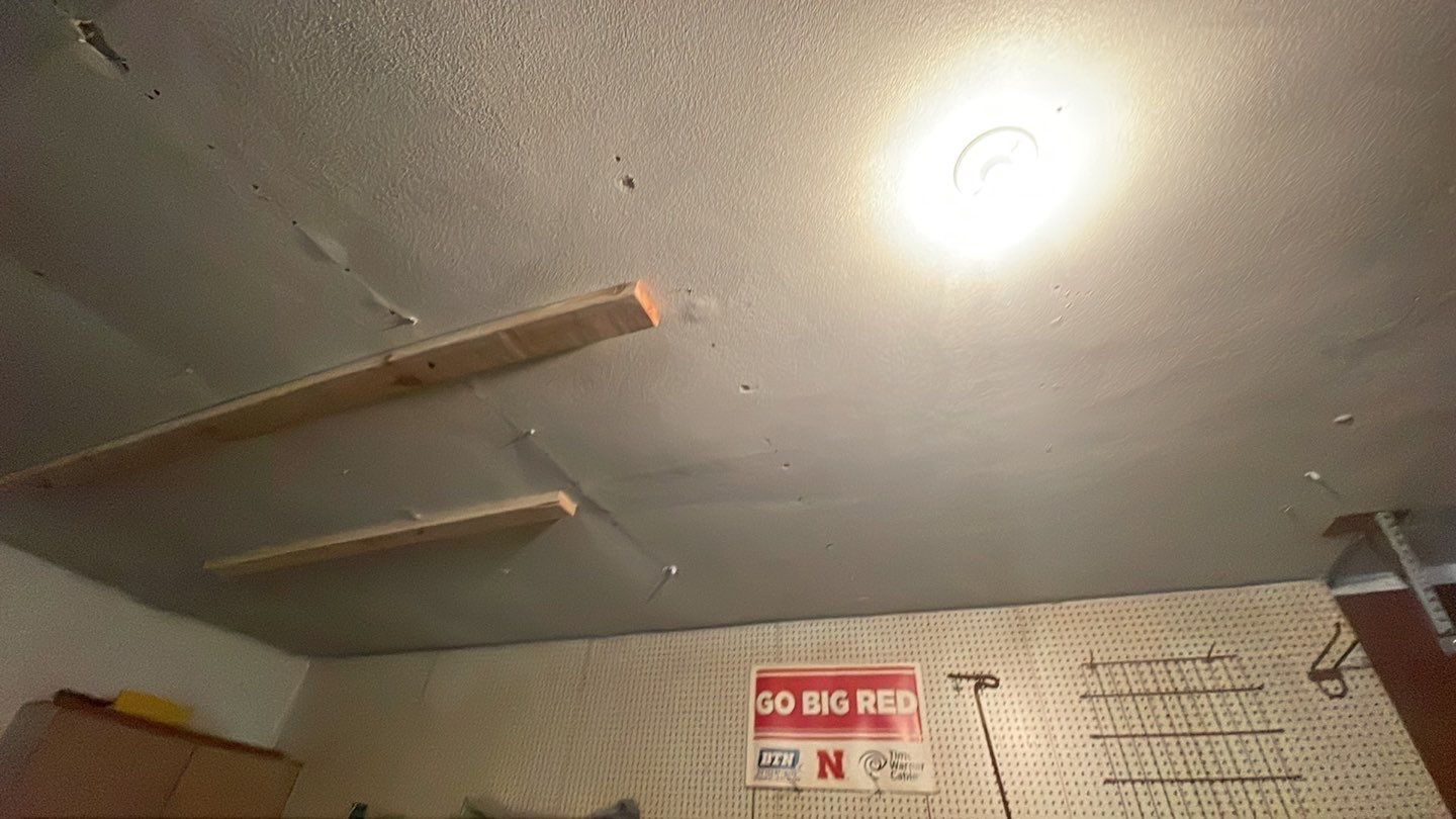 A garage with a light on the ceiling and a sign on the wall.