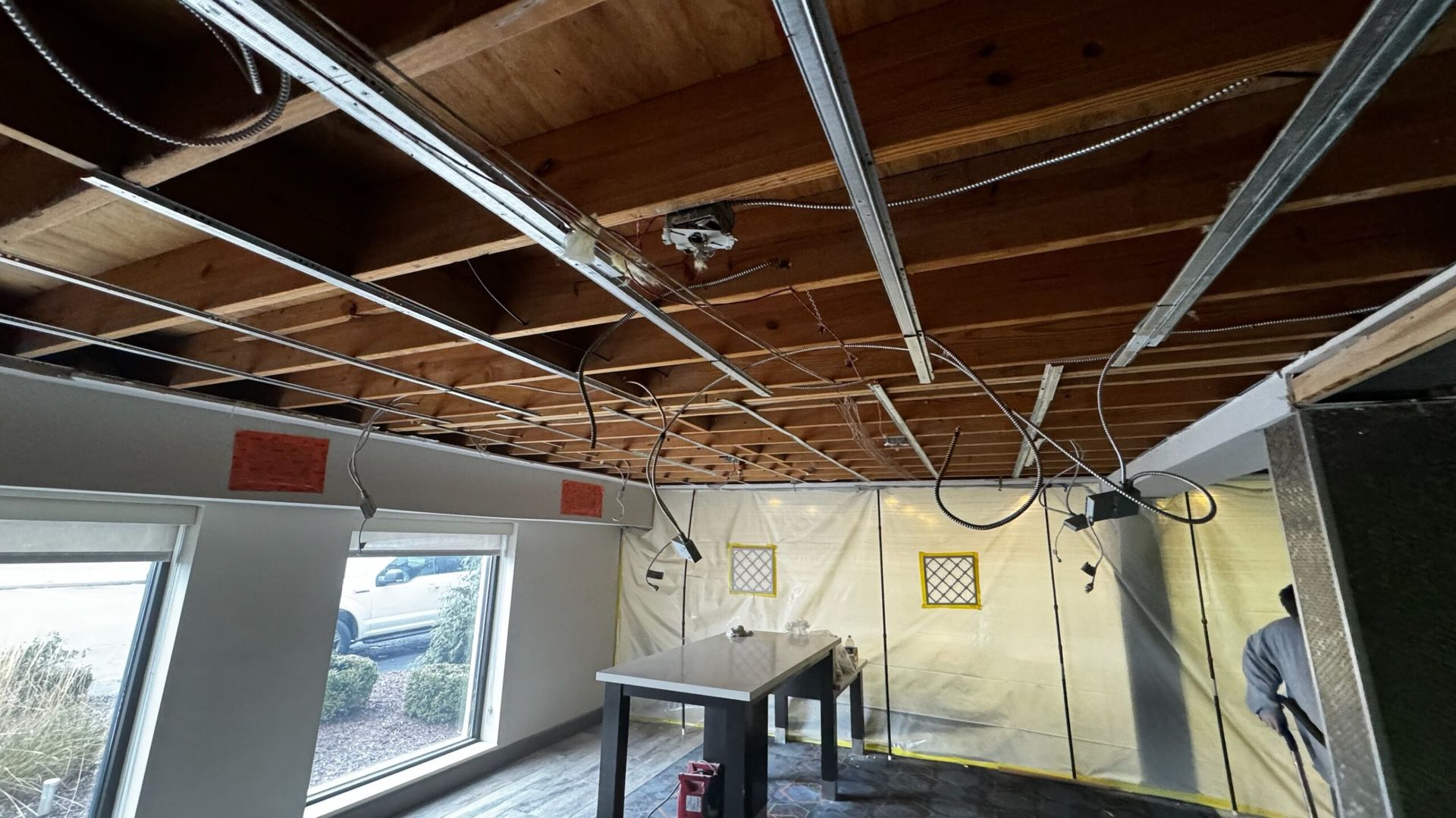 A room with a wooden ceiling and a table in it