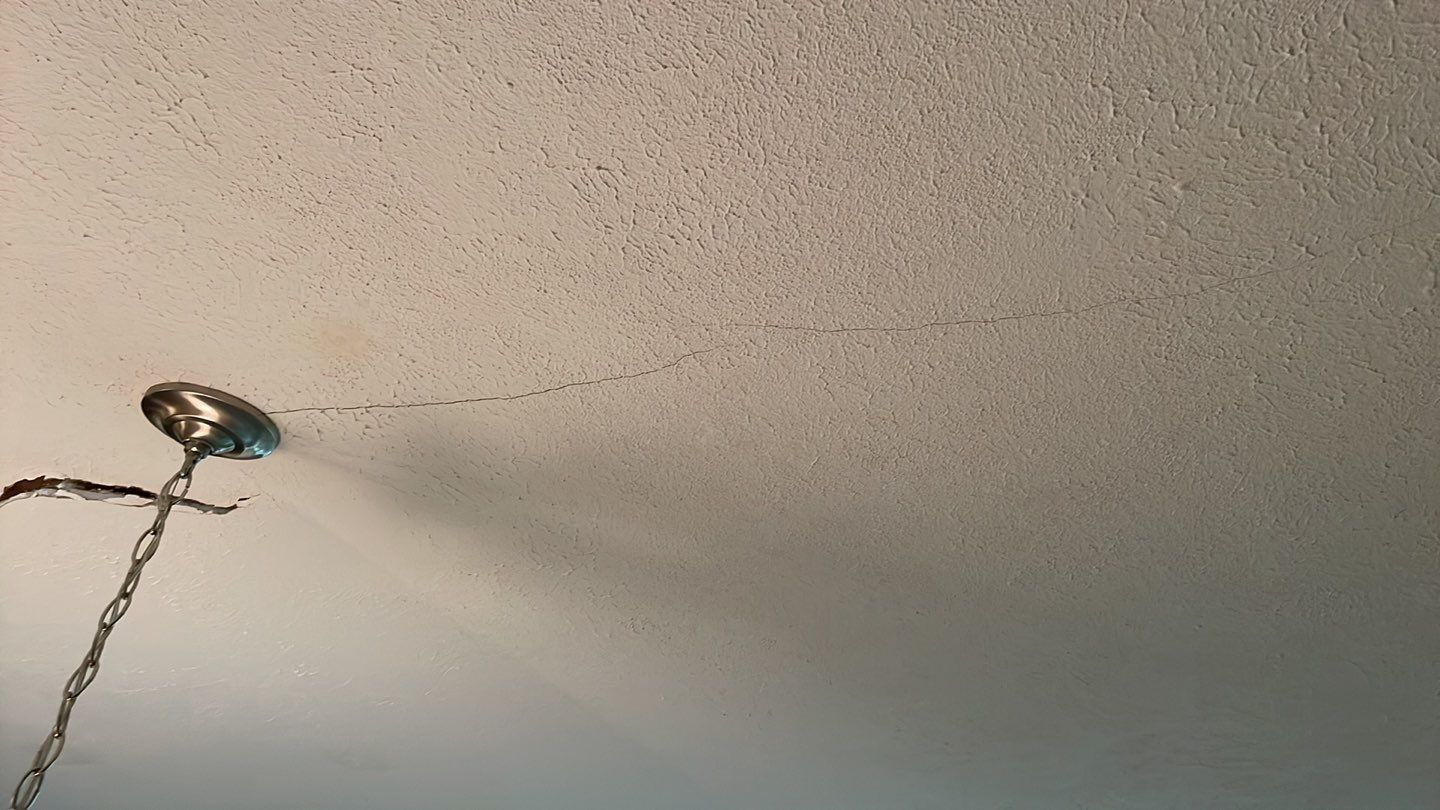 A lamp is hanging from the ceiling and water is coming out of it.