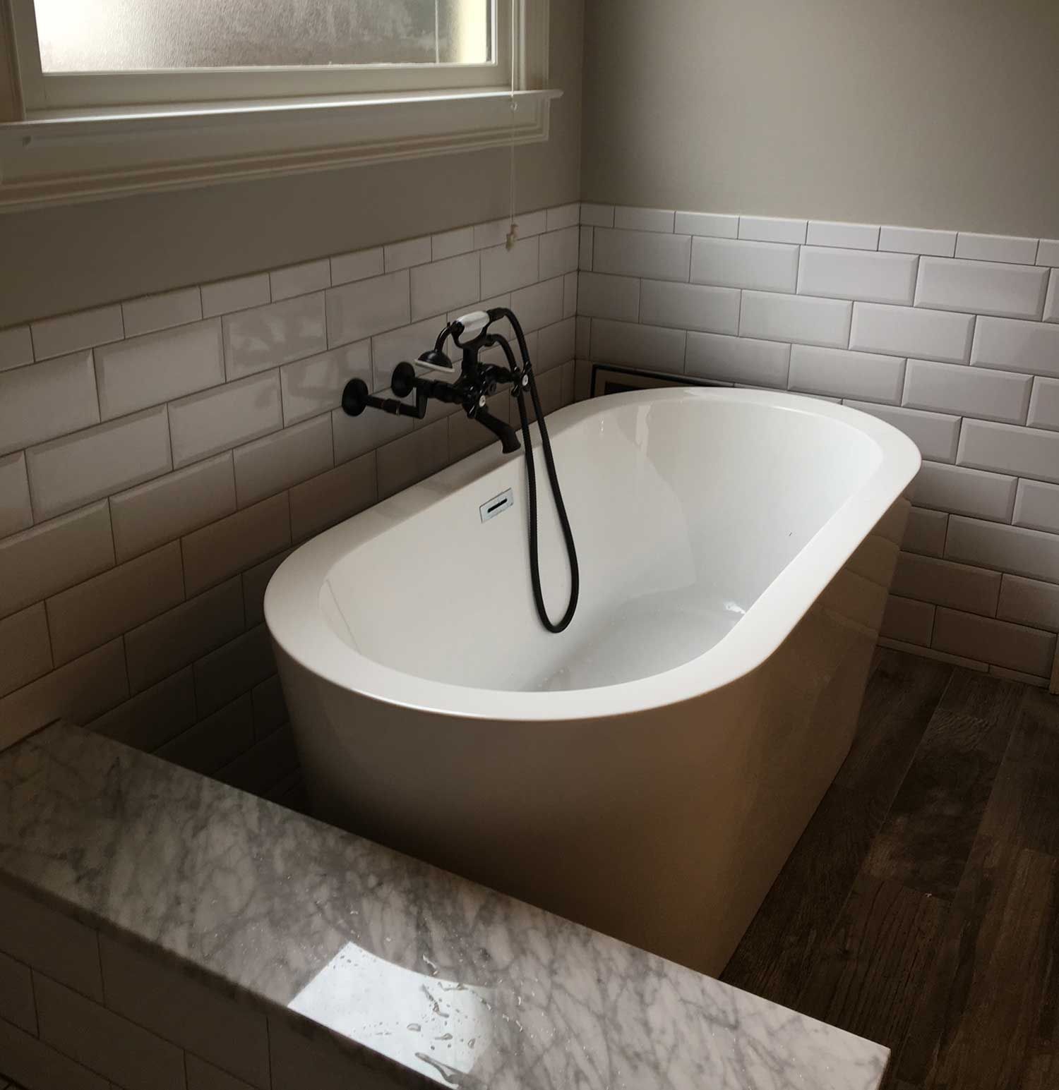 a bathtub in a bathroom next to a window