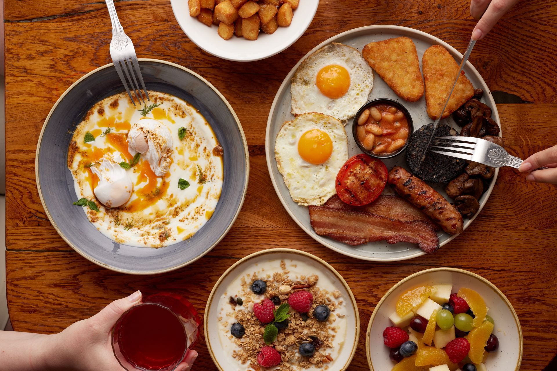 A table topped with plates of food and a drink.
