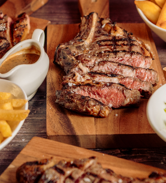 A white plate topped with steak and french fries