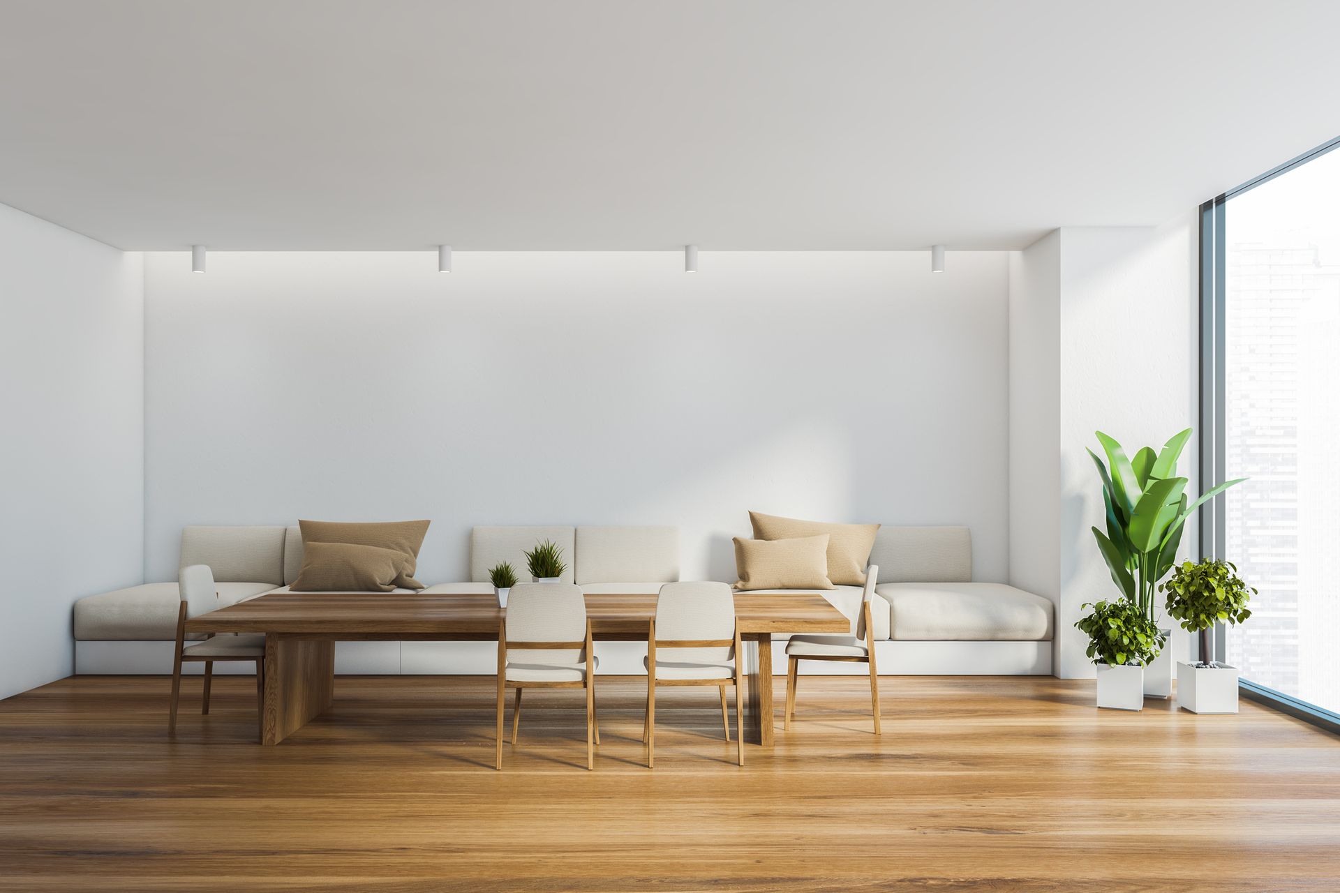 A dining room with a long table and chairs and a couch.