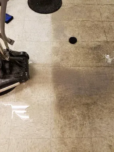 Floor being cleaned; half clean, half dirty, demonstrating the cleaning process.