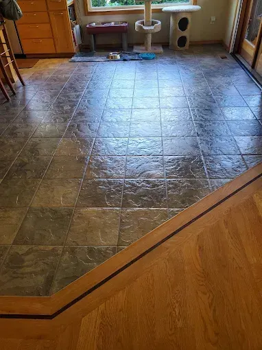 Commercial kitchen with stainless steel range and ventilation hood, and a red fire suppression system.