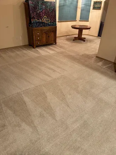 Ceiling-mounted fire sprinkler head in an office setting; chrome with red glass bulb.