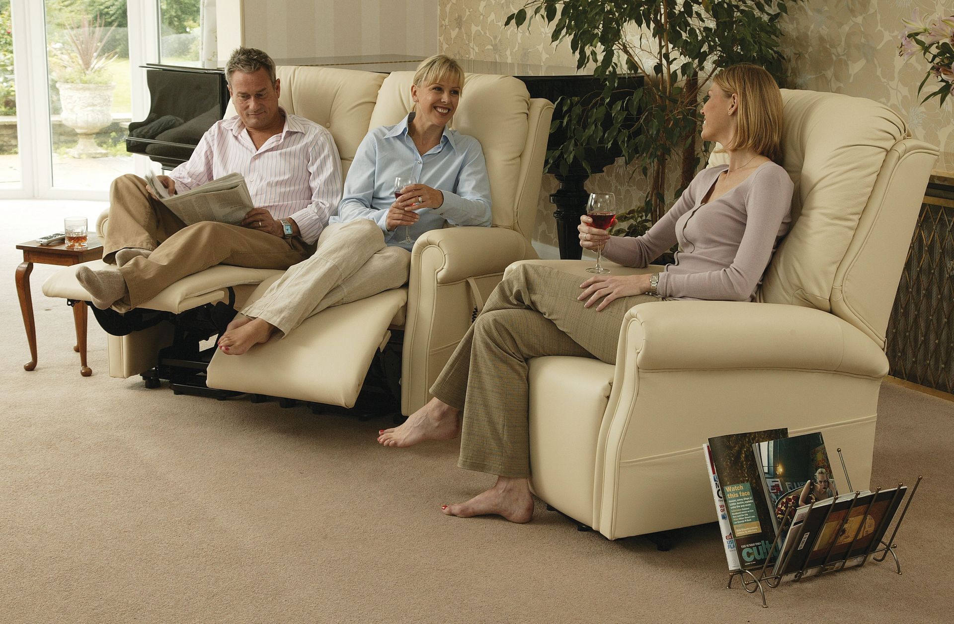 Three people are sitting on a couch in a living room