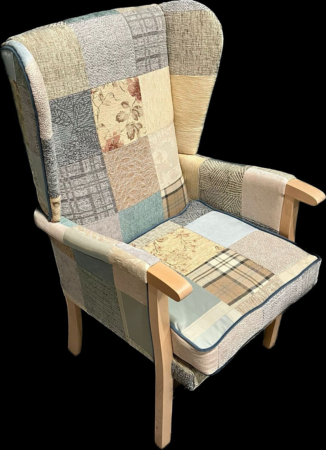 A chair with a patchwork pattern and wooden arm rests on a black background.