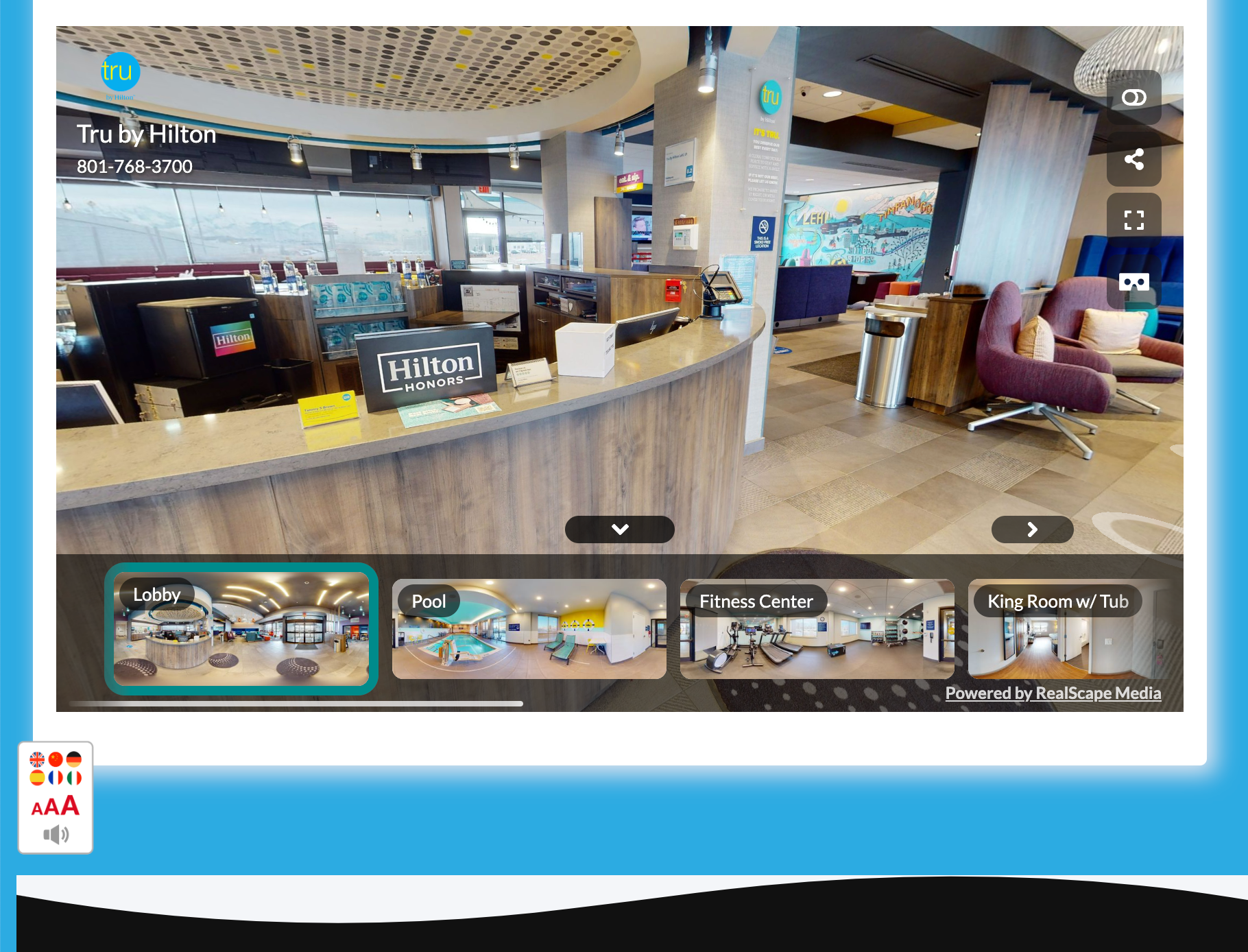 Hotel lobby with front desk, seating area, and multiple room view options.