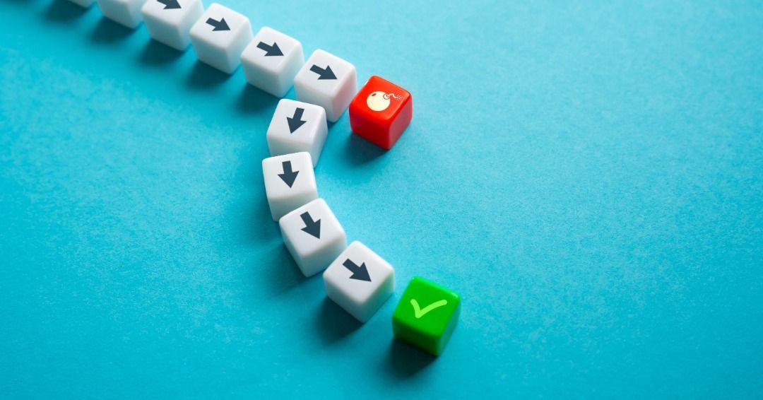 White blocks with arrows curve towards a red, flaming block, then a green checkmark. Blue background.