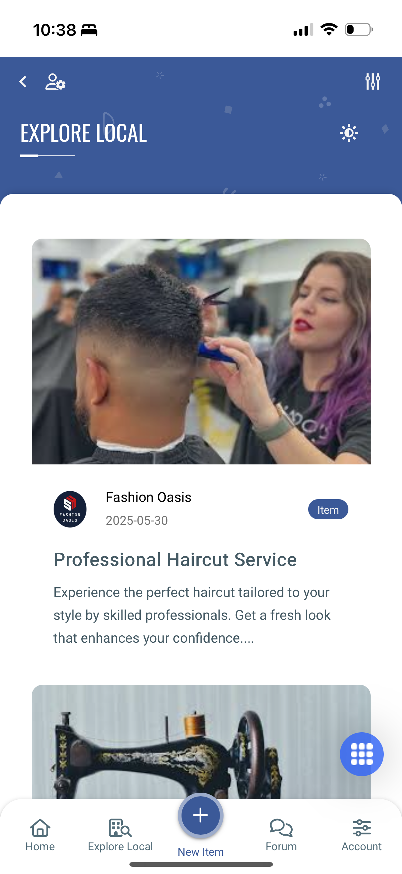 A hairdresser with purple hair cuts a man's hair in a salon.