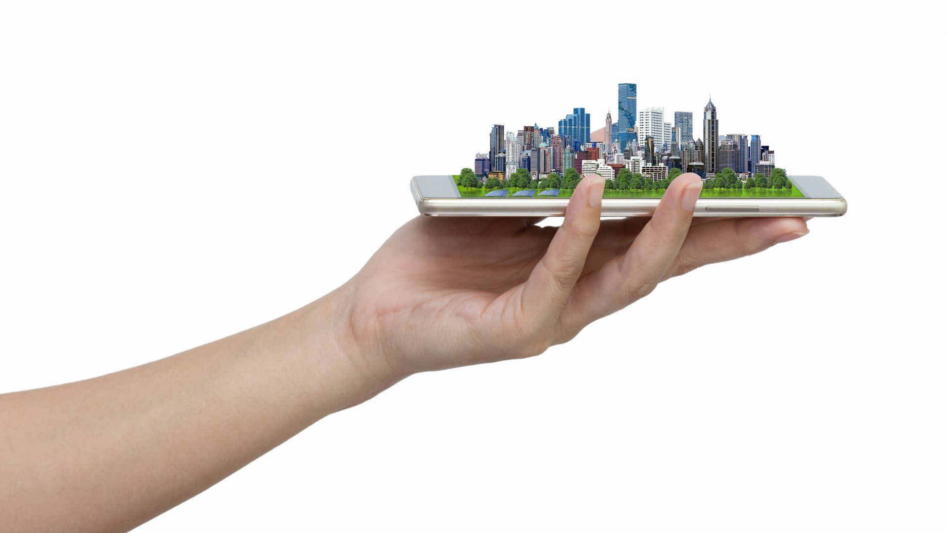 Hand holding a smartphone displaying a miniature city with buildings and greenery.