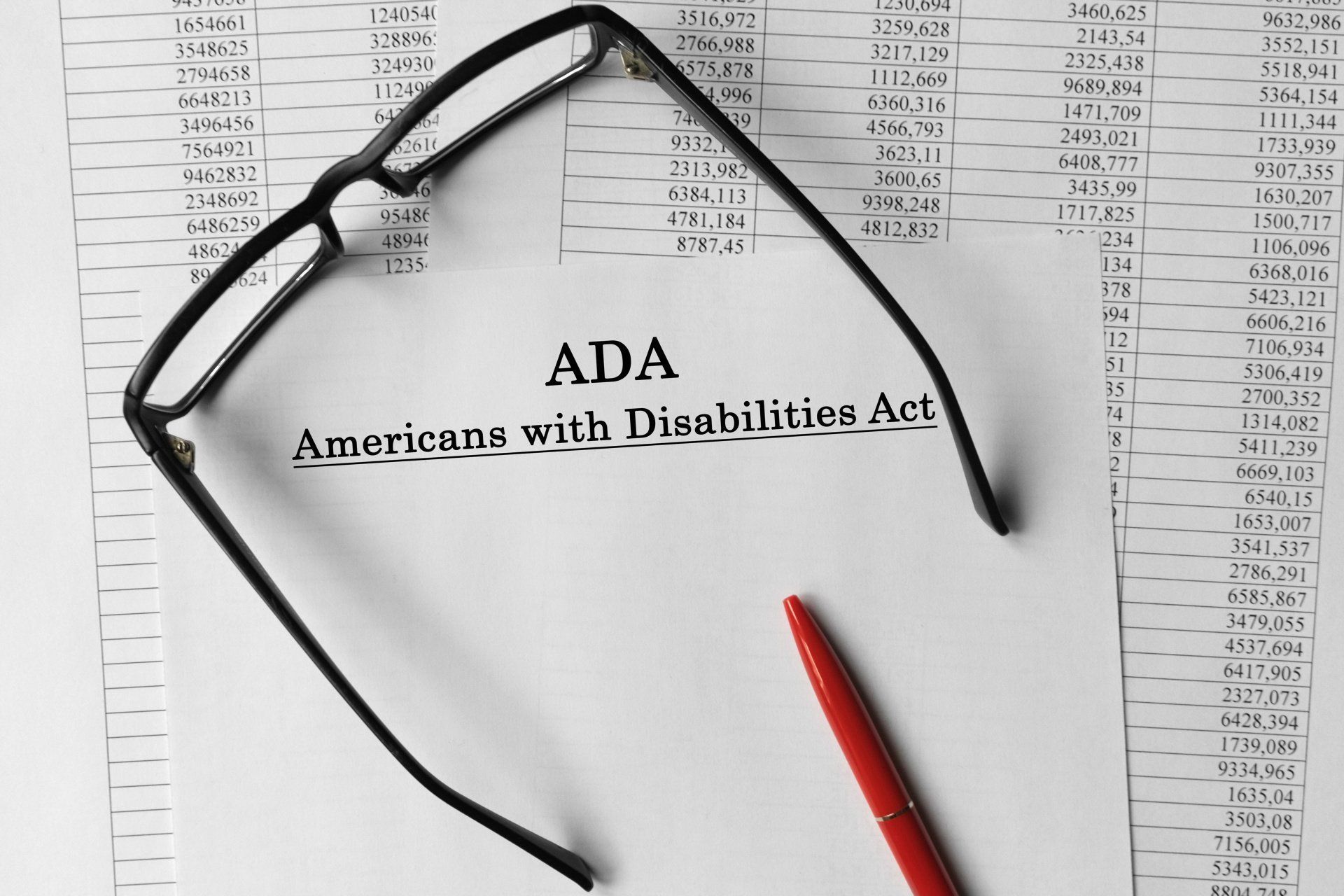 ADA document with glasses and a red pen on a spreadsheet background.