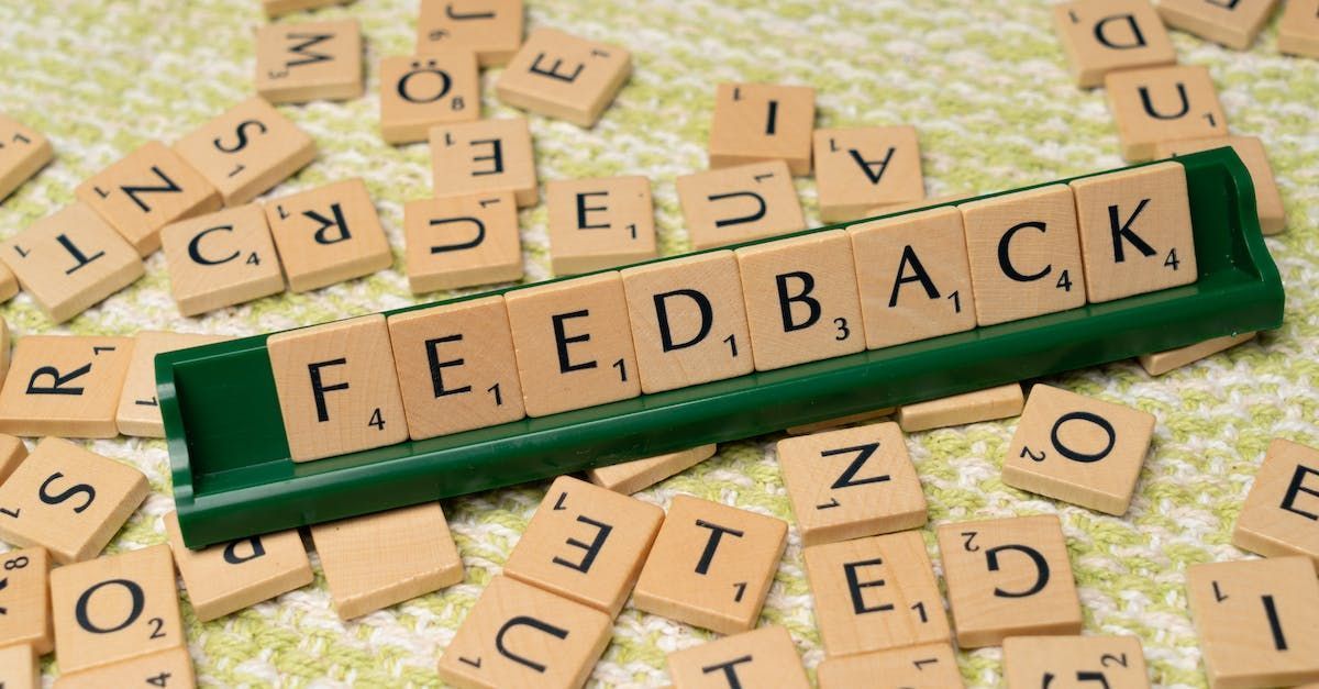 "Feedback" spelled out on Scrabble tiles, scattered around.