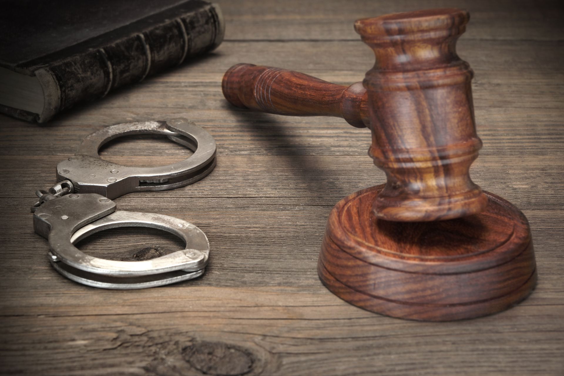 Gavel and handcuffs on a wooden table, illustrating domestic violence charge bail bond.