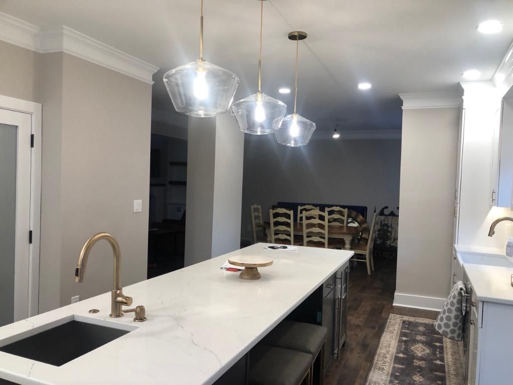 A kitchen with a large island and a sink.