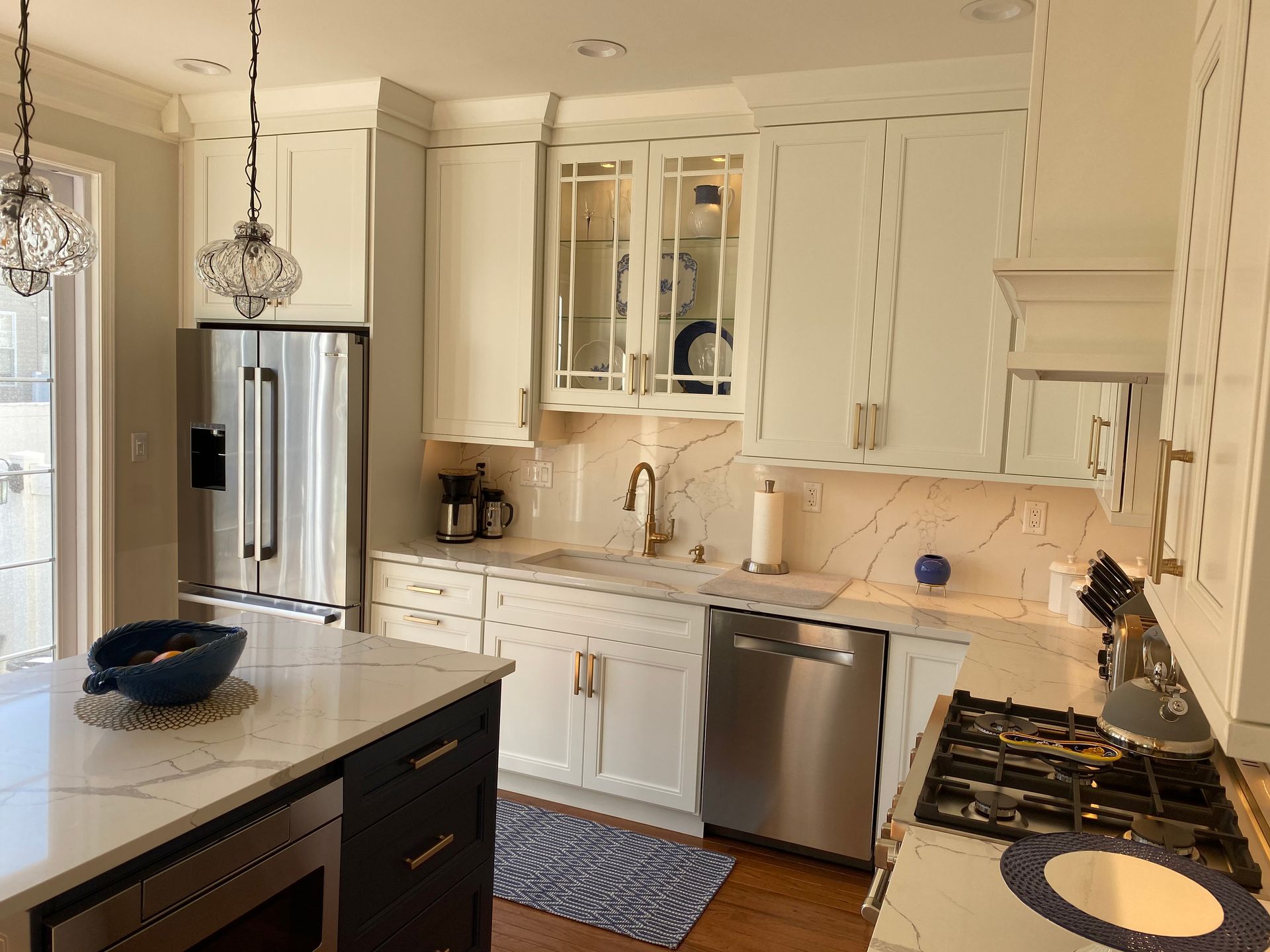 A kitchen with white cabinets and stainless steel appliances.