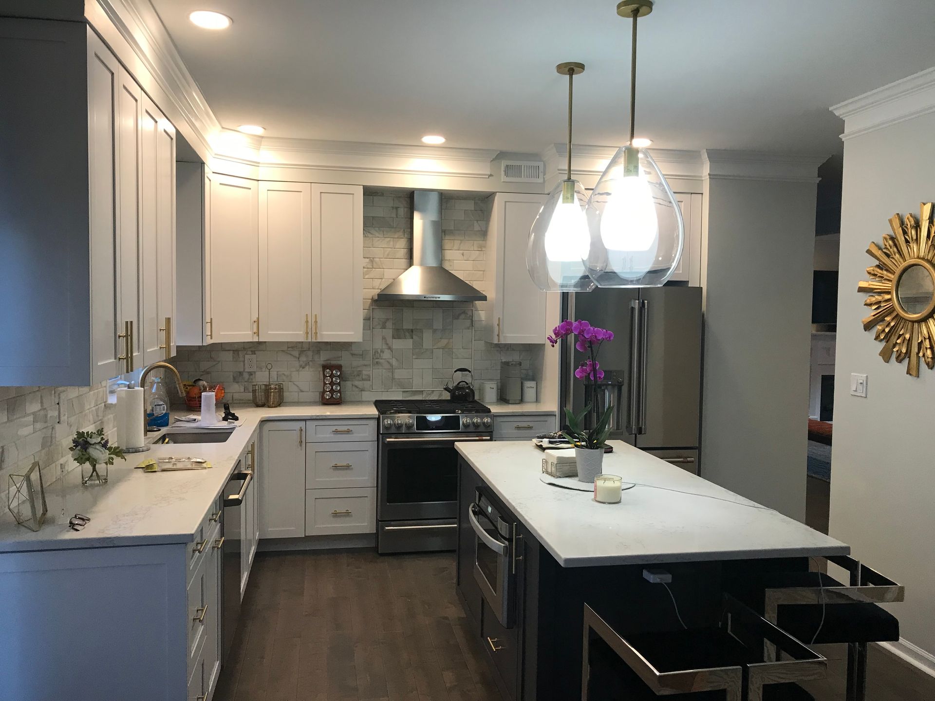 A kitchen with white cabinets and stainless steel appliances