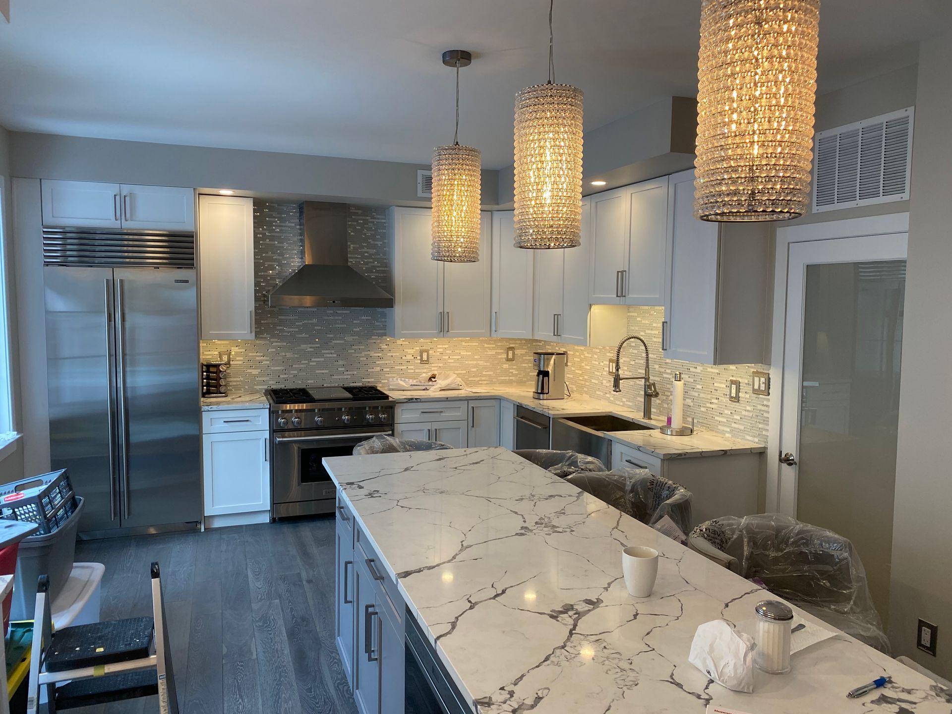 A kitchen with white cabinets and stainless steel appliances