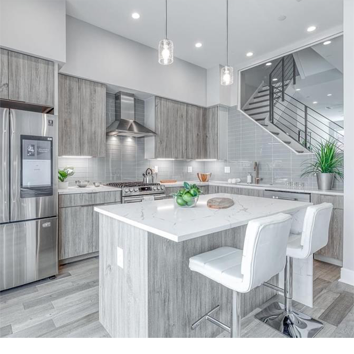 A kitchen with stainless steel appliances and wooden cabinets