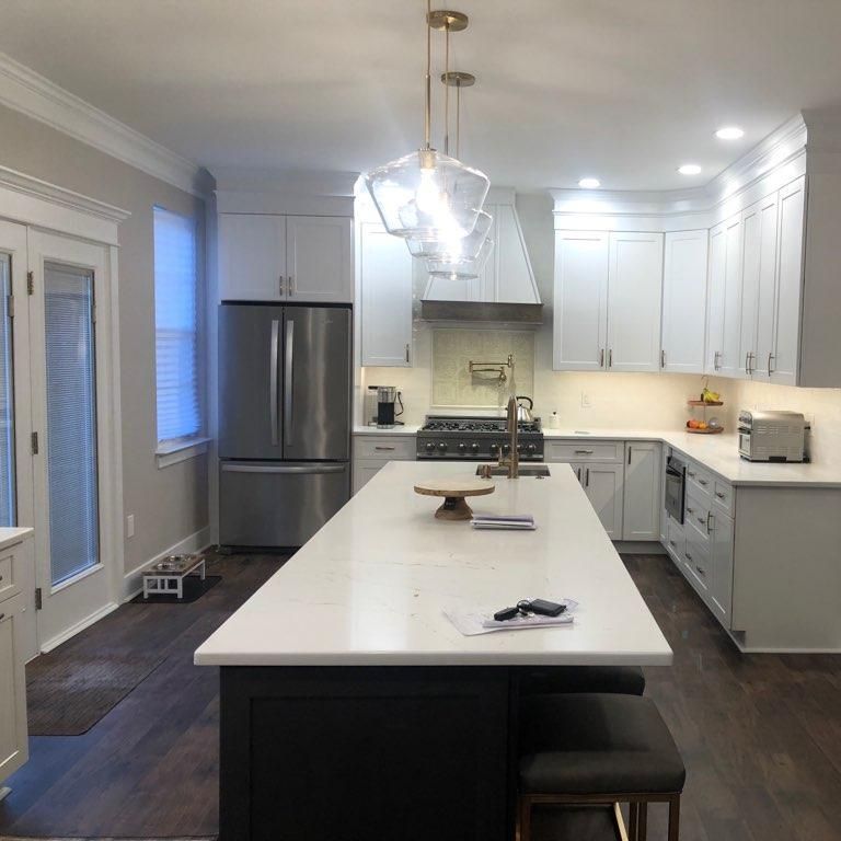 A kitchen with white cabinets and stainless steel appliances