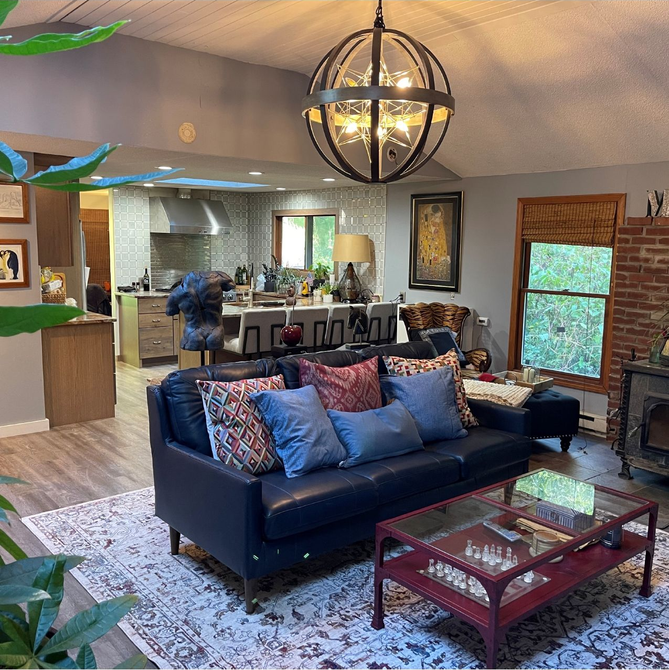 Someone looking at a catalog with a laptop and cup of coffee