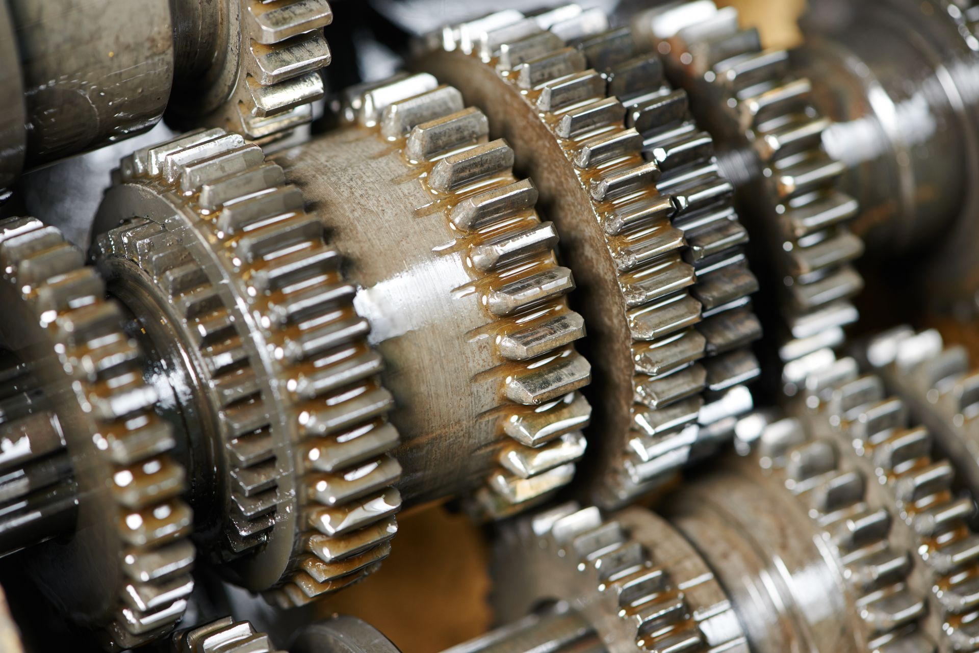 Close-up of interlocking metal gears in a machine mechanism Close-up of interlocking metal gears in a machine mechanism