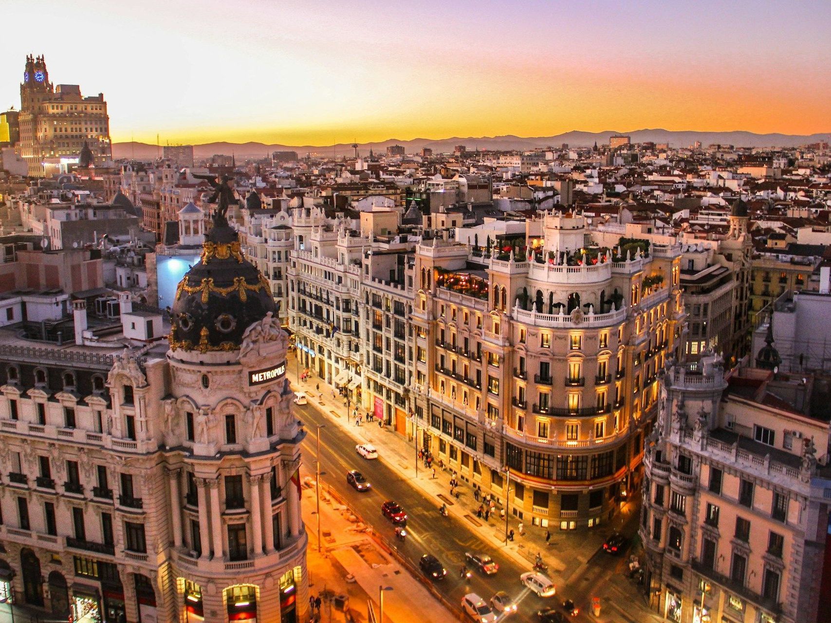 An aerial view of a city at sunset with a lot of buildings.