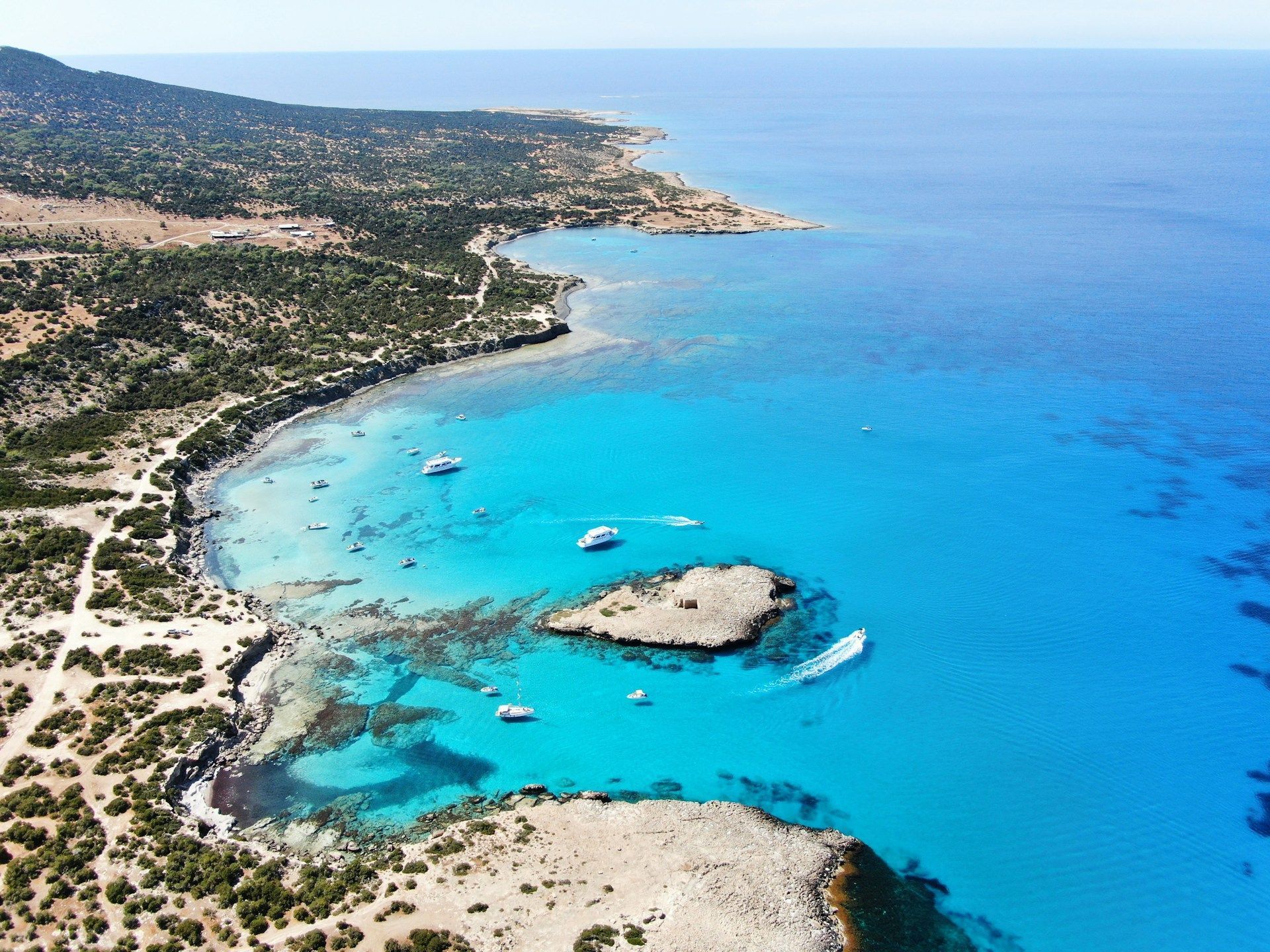 An aerial view of a small island in the middle of a large body of water.