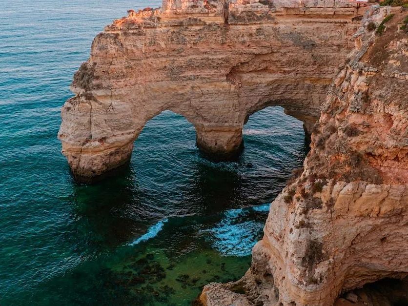 An aerial view of a rocky cliff overlooking the ocean.