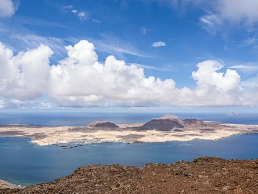 A view of a large body of water with mountains in the background.