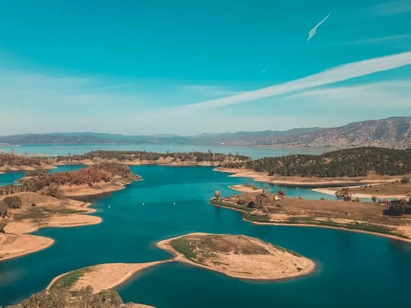 An aerial view of a lake with small islands in it