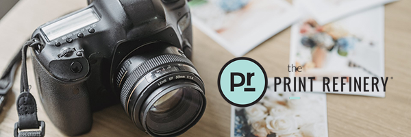 a camera with a lens and prints on a table