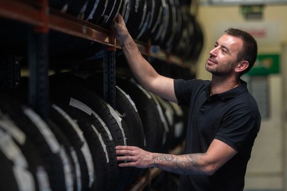 A man is looking for a tire. A man is looking for a tire.