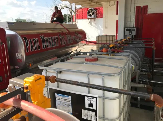 Man Sitting on Top of a Tanker Truck — Jacksonville, FL — Paul Murray Oil Inc