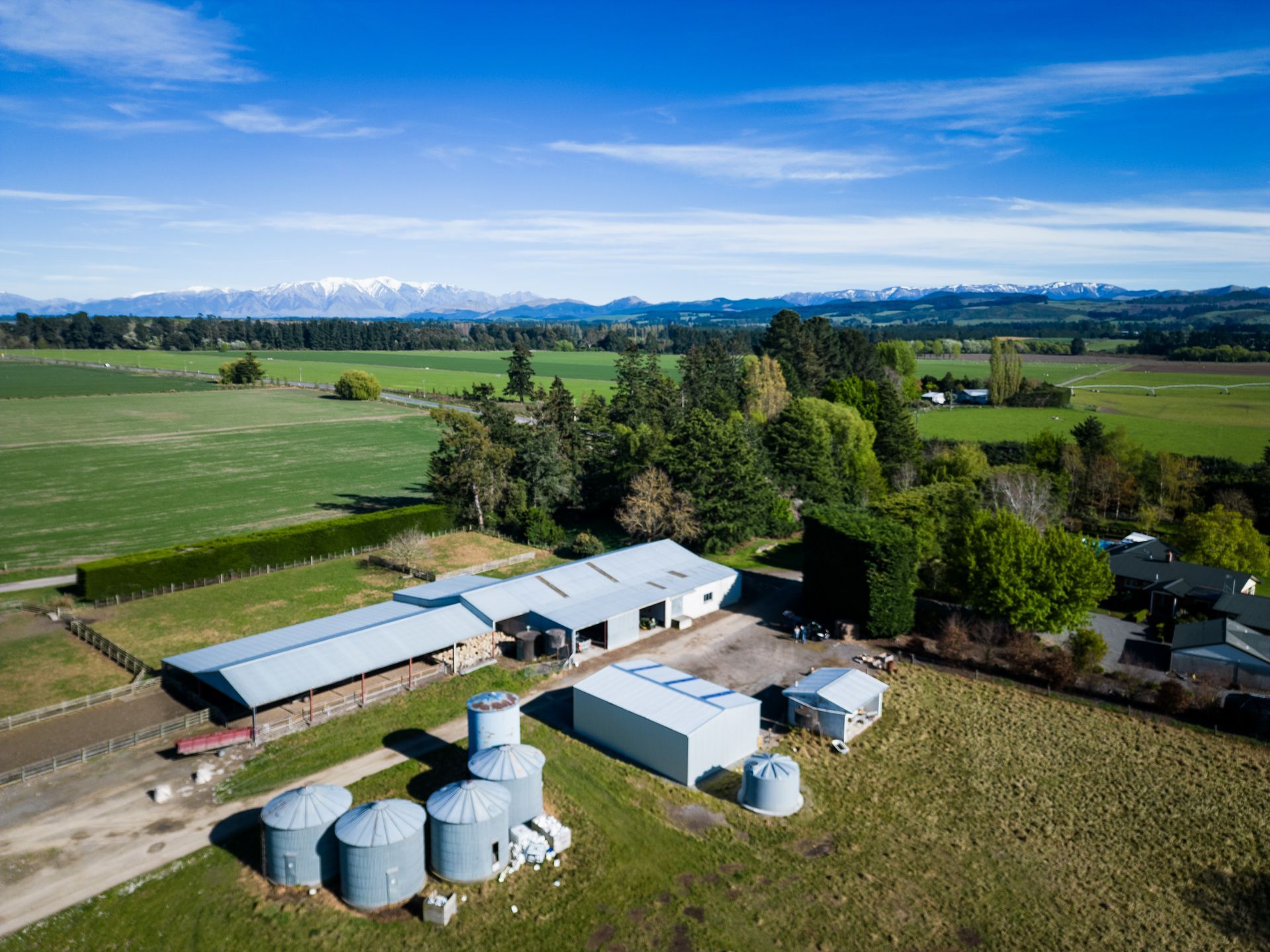 An aerial view of a farm with a lot of buildings and silos.